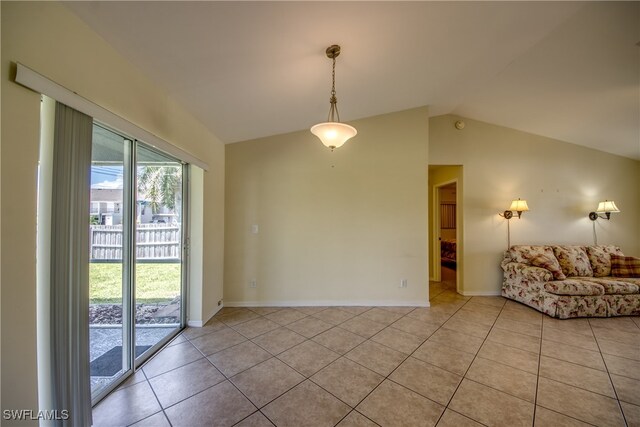 tiled empty room with vaulted ceiling