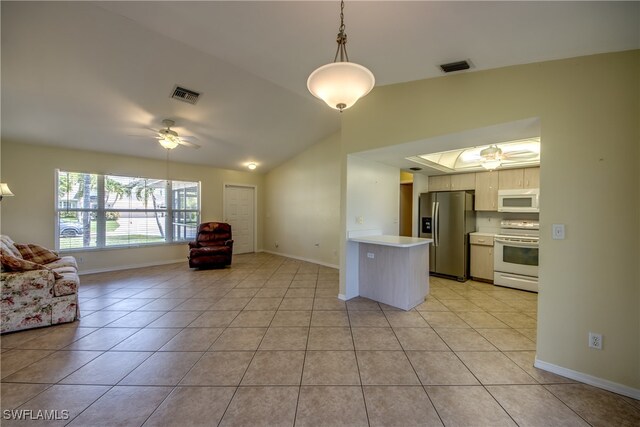 kitchen with white appliances, light tile patterned flooring, lofted ceiling, ceiling fan, and decorative light fixtures