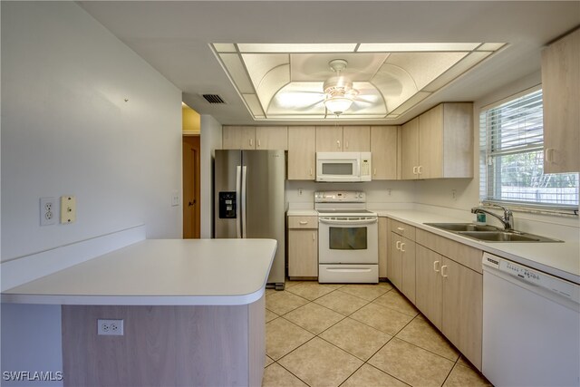 kitchen with white appliances, sink, ceiling fan, and light brown cabinetry