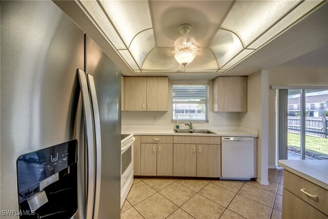 kitchen with ceiling fan, white appliances, sink, and light brown cabinetry