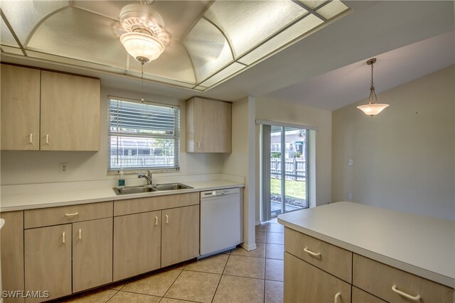 kitchen featuring light tile patterned floors, hanging light fixtures, dishwasher, sink, and light brown cabinets