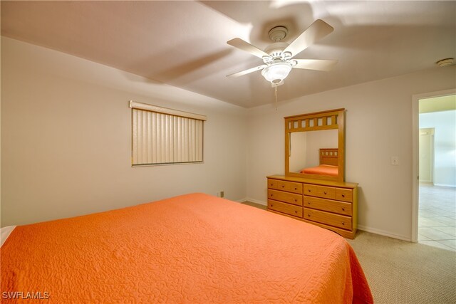 bedroom with ceiling fan and light colored carpet