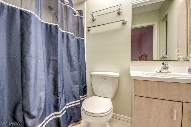 bathroom featuring vanity, toilet, and tile patterned flooring