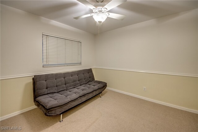 sitting room featuring ceiling fan and light colored carpet