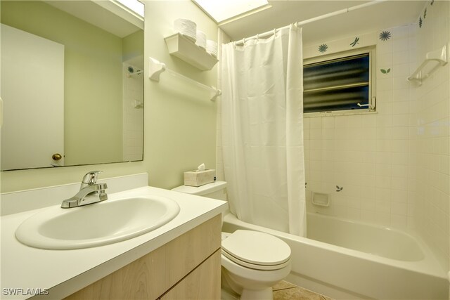 full bathroom featuring shower / bath combo with shower curtain, toilet, tile patterned floors, and vanity