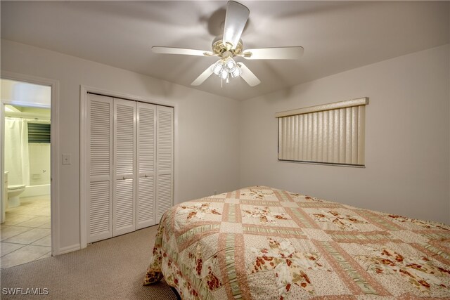 carpeted bedroom with ceiling fan and a closet