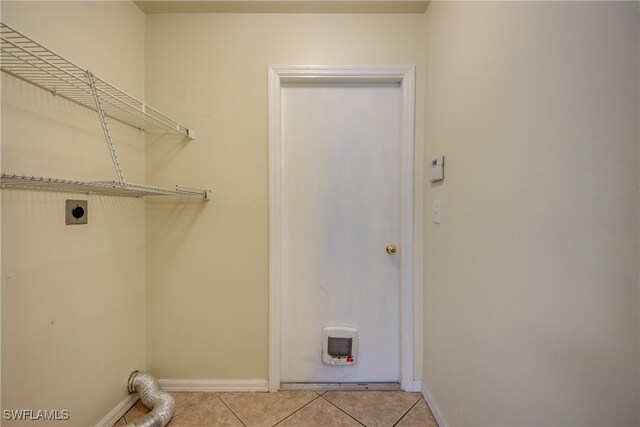 laundry area with light tile patterned floors and electric dryer hookup