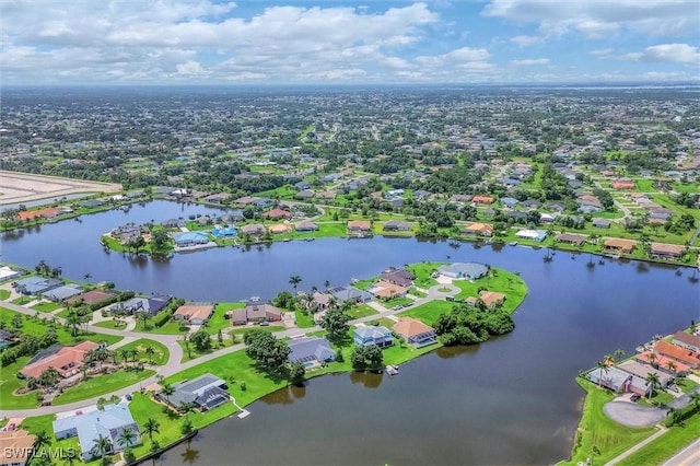 drone / aerial view featuring a residential view and a water view