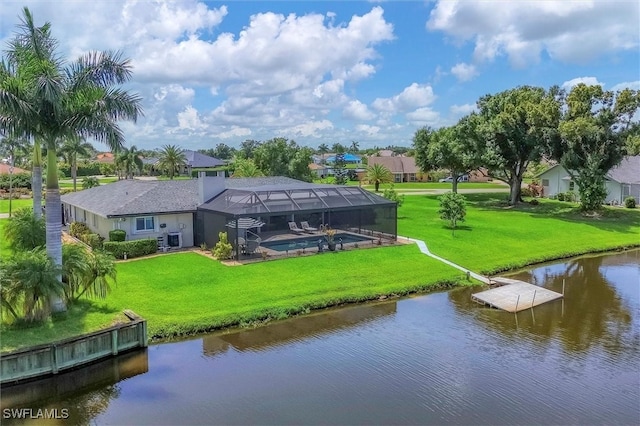 back of property featuring a lanai, a water view, and a yard