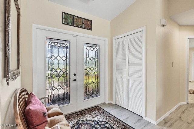 entryway with french doors and light hardwood / wood-style floors