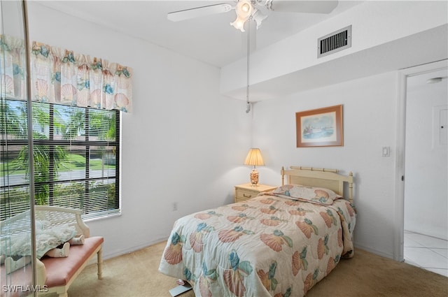 bedroom with ceiling fan and light carpet