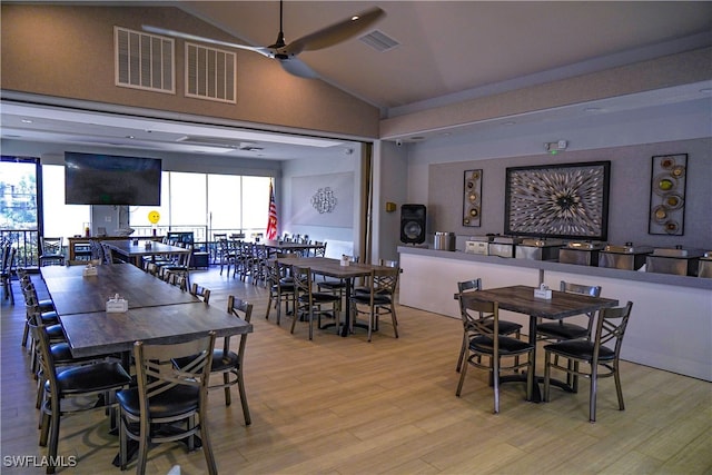 dining area featuring ceiling fan, light hardwood / wood-style flooring, and lofted ceiling