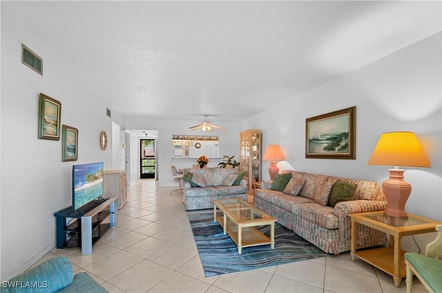 living room featuring ceiling fan and light tile patterned floors