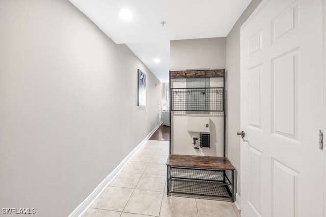 hall featuring light tile patterned floors