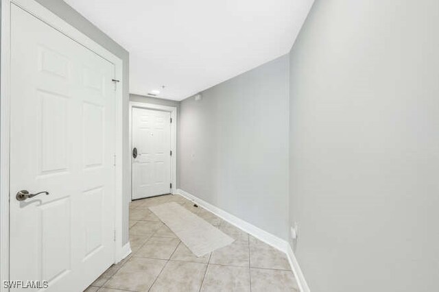 hall with light tile patterned floors