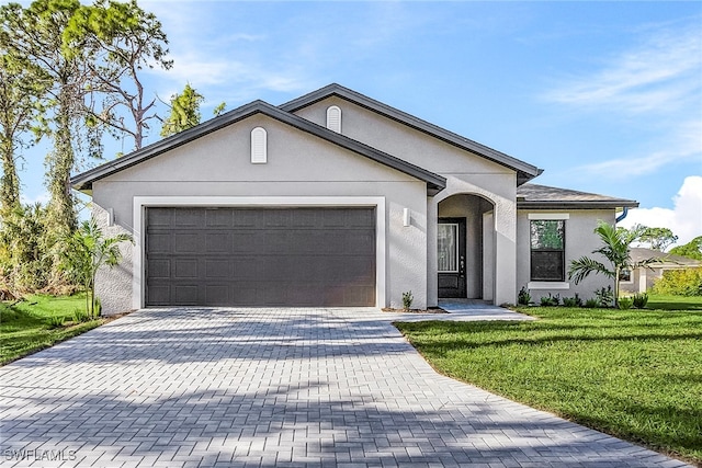 single story home with a front lawn, decorative driveway, an attached garage, and stucco siding