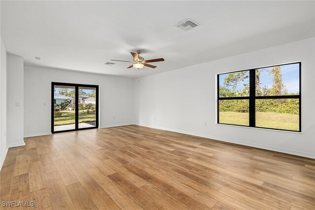 spare room featuring ceiling fan and light hardwood / wood-style floors