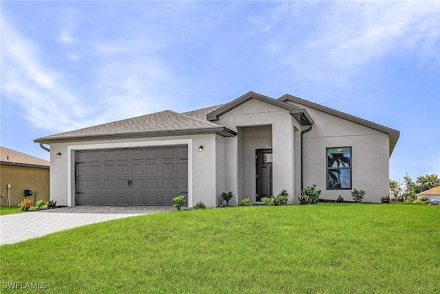 view of front of house featuring decorative driveway, stucco siding, a garage, and a front yard