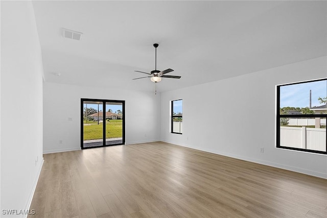 empty room with light wood finished floors, ceiling fan, and baseboards