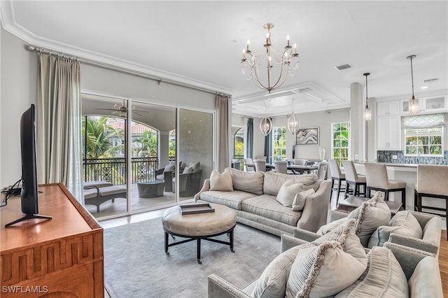 living room featuring ceiling fan with notable chandelier, crown molding, and coffered ceiling