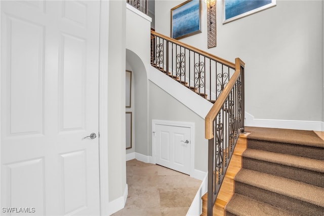 staircase with tile patterned floors