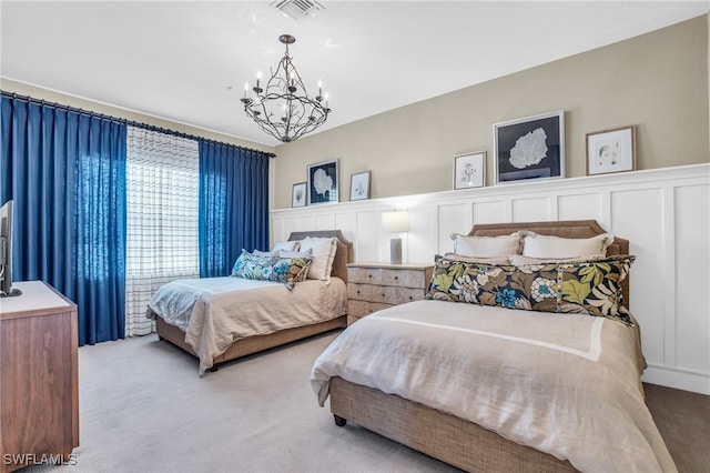 carpeted bedroom featuring a chandelier