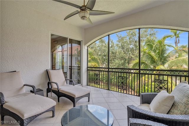 sunroom / solarium featuring ceiling fan