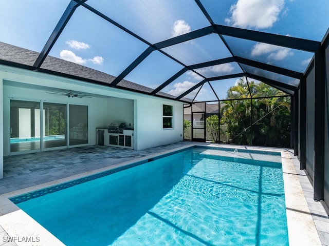 view of swimming pool with a patio, ceiling fan, grilling area, and glass enclosure