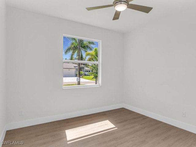 empty room featuring ceiling fan and hardwood / wood-style floors