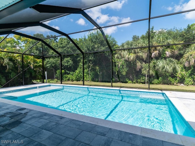 view of swimming pool with a patio and a lanai