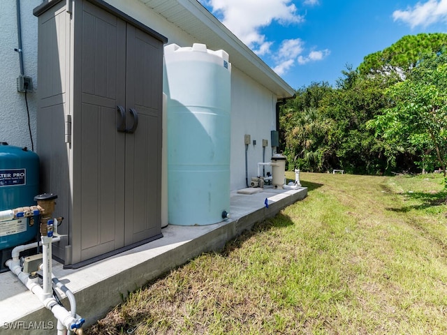 view of side of property featuring a shed and a lawn