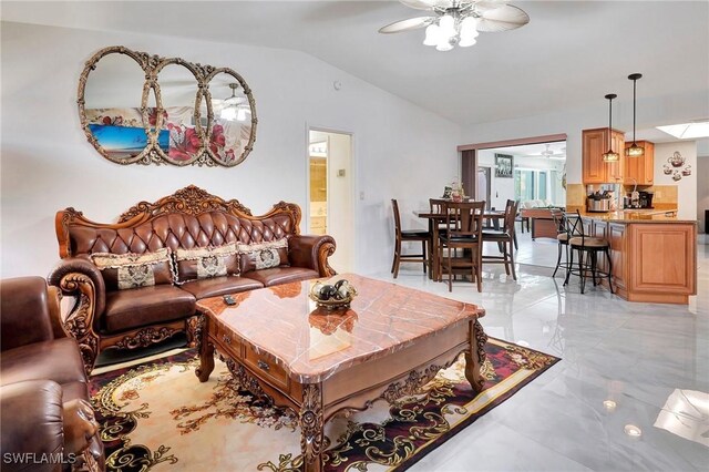 tiled living room featuring ceiling fan and vaulted ceiling