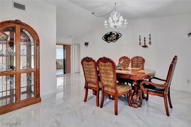 tiled dining area with a notable chandelier and vaulted ceiling