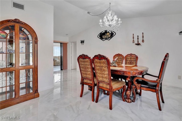 dining area with an inviting chandelier and lofted ceiling