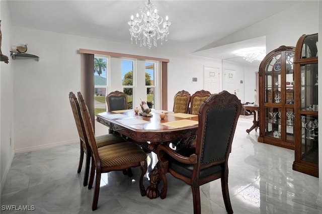 dining space with a notable chandelier, light tile patterned flooring, and lofted ceiling