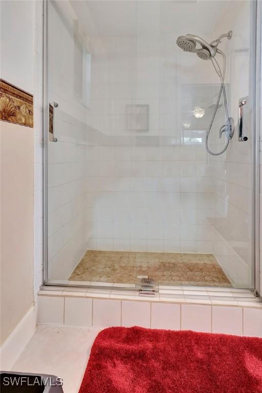 bathroom with a shower with door