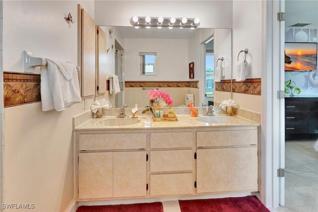 bathroom featuring double sink vanity and tile patterned flooring