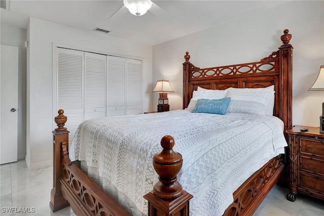 bedroom featuring ceiling fan, light tile patterned floors, and a closet