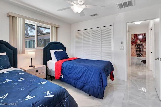 bedroom with light tile patterned flooring, a closet, and ceiling fan