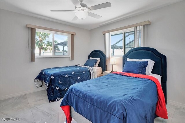 tiled bedroom featuring ceiling fan