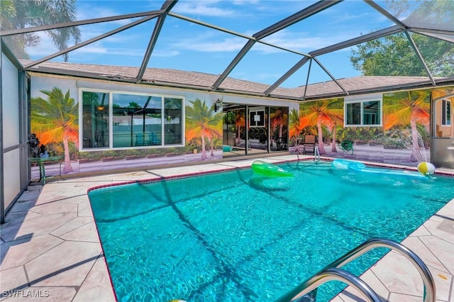 view of pool featuring glass enclosure and a patio area