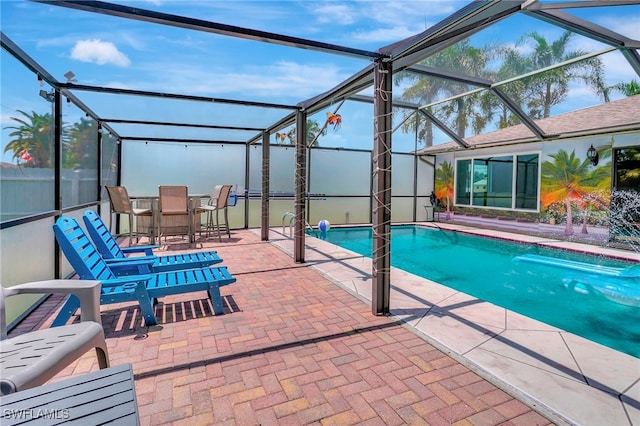 view of swimming pool with a lanai and a patio area