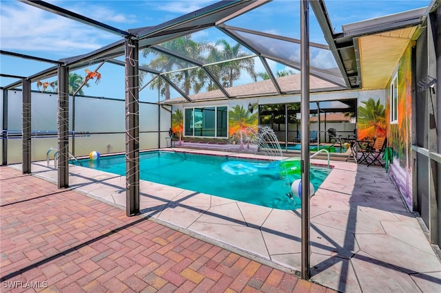 view of pool featuring a patio area, pool water feature, and glass enclosure