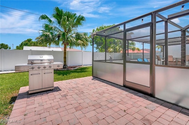 view of patio featuring a lanai