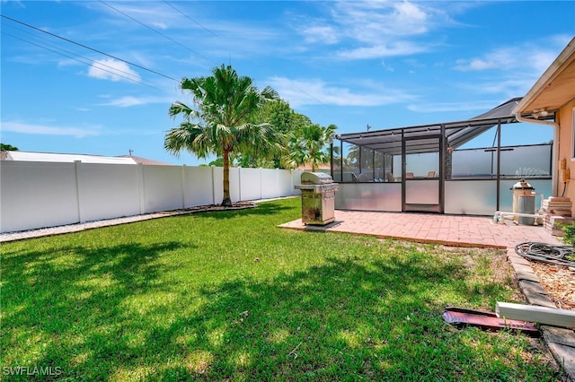 view of yard featuring a patio area and a lanai