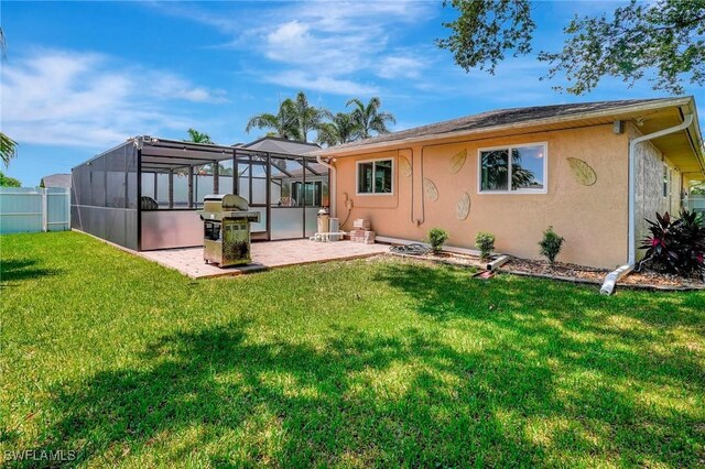 back of house with a lanai, a yard, and a patio area