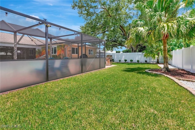 view of yard featuring glass enclosure