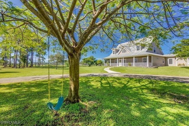 exterior space featuring covered porch and a front yard