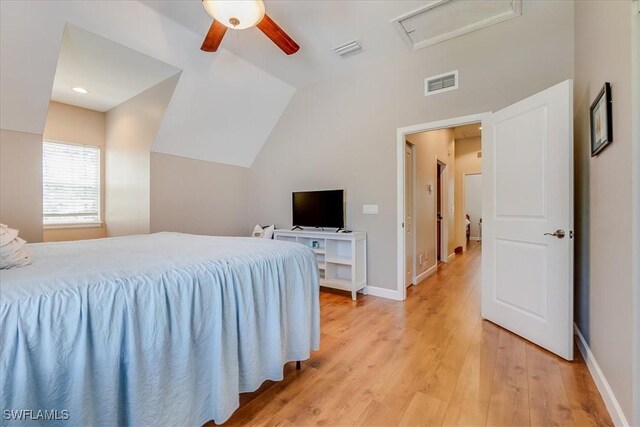 bedroom with ceiling fan, light hardwood / wood-style flooring, and lofted ceiling