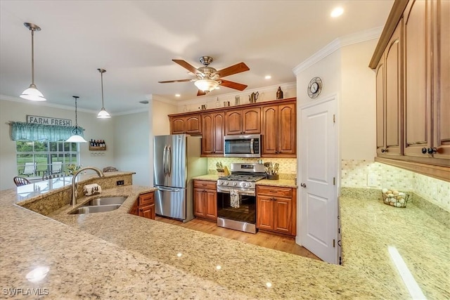 kitchen featuring stainless steel appliances, a sink, backsplash, brown cabinetry, and pendant lighting